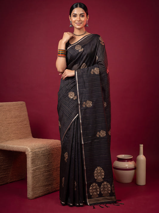 Woman wearing black satin silk saree with zari butta (metallic motif) work and black blouse