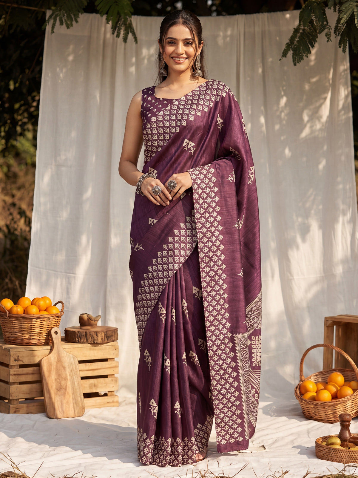 Woman wearing wine cotton blend saree with traditional indian motif work and wine blouse