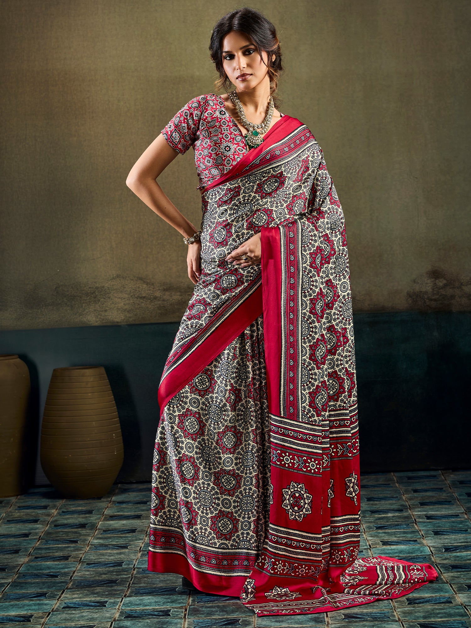 Woman wearing maroon satin saree with ajrak block-print motif work and maroon blouse