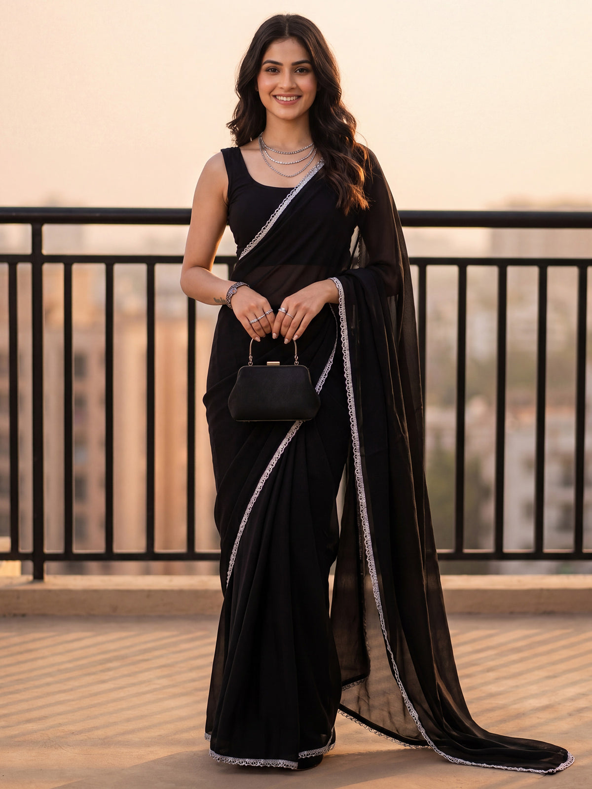 Woman wearing black georgette saree with clean solid-tone finish and black blouse