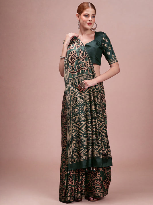 Woman wearing dark green silk blend saree with traditional indian motif work and dark green blouse