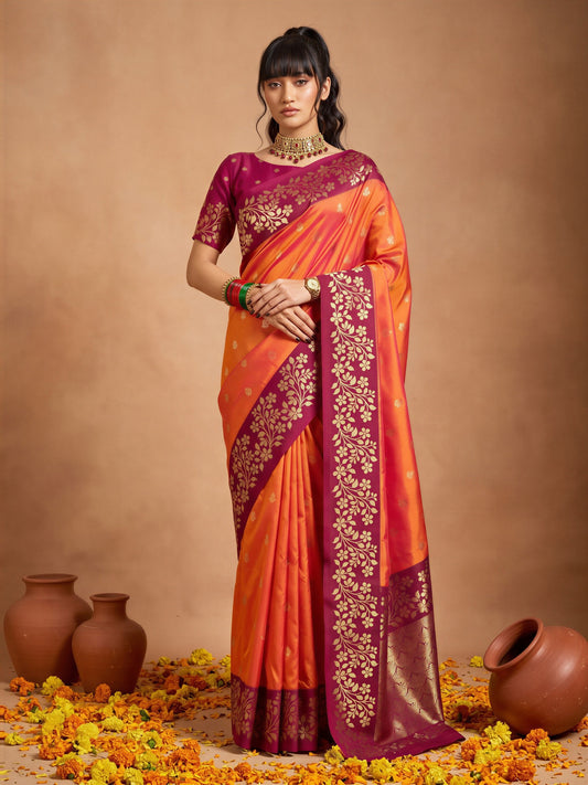 Woman wearing orange cotton blend saree with all-over floral design and magenta blouse