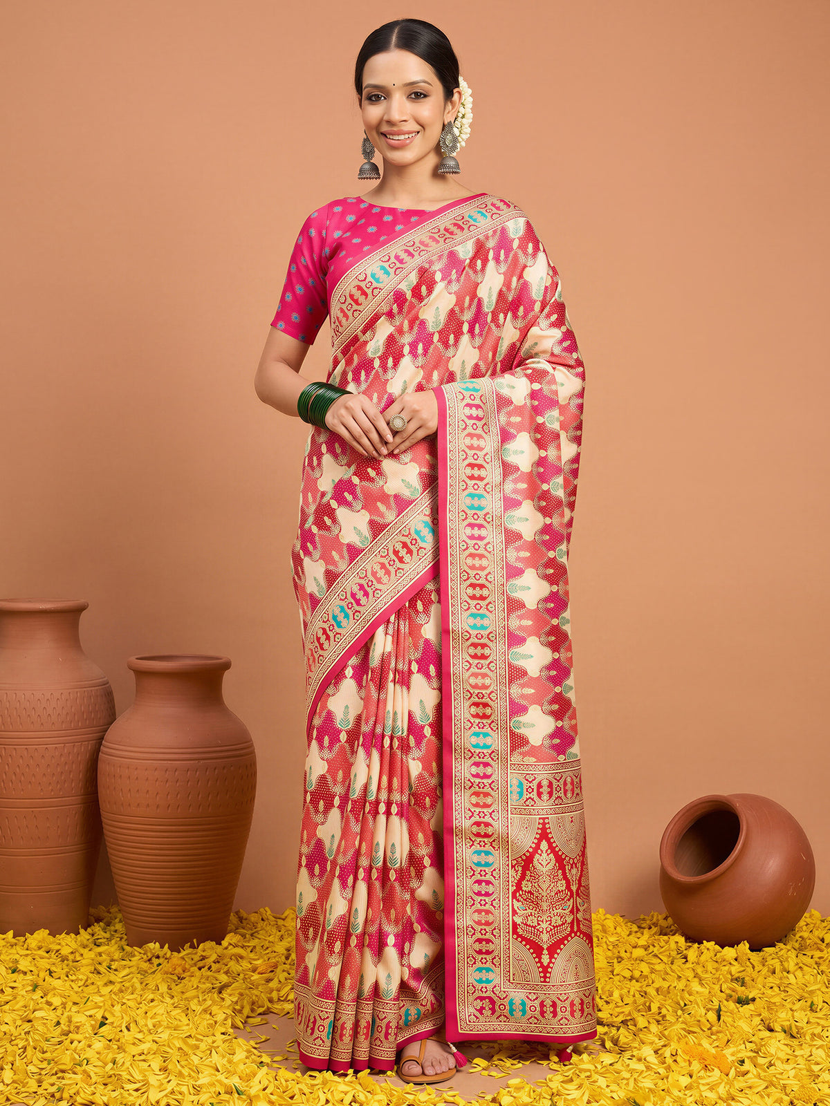 Woman wearing pink silk blend saree with metallic foil print work and pink blouse