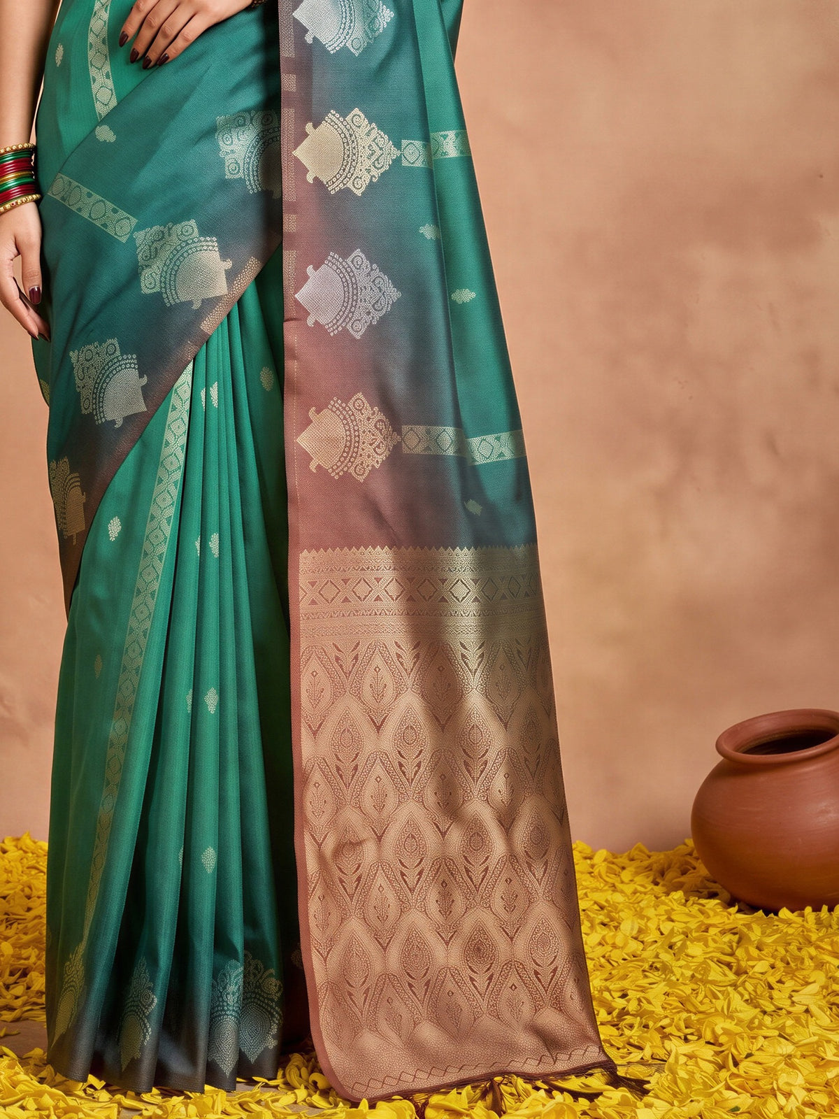 Pallu detail of teal green cotton blend saree showing ornamented surface design and solid border