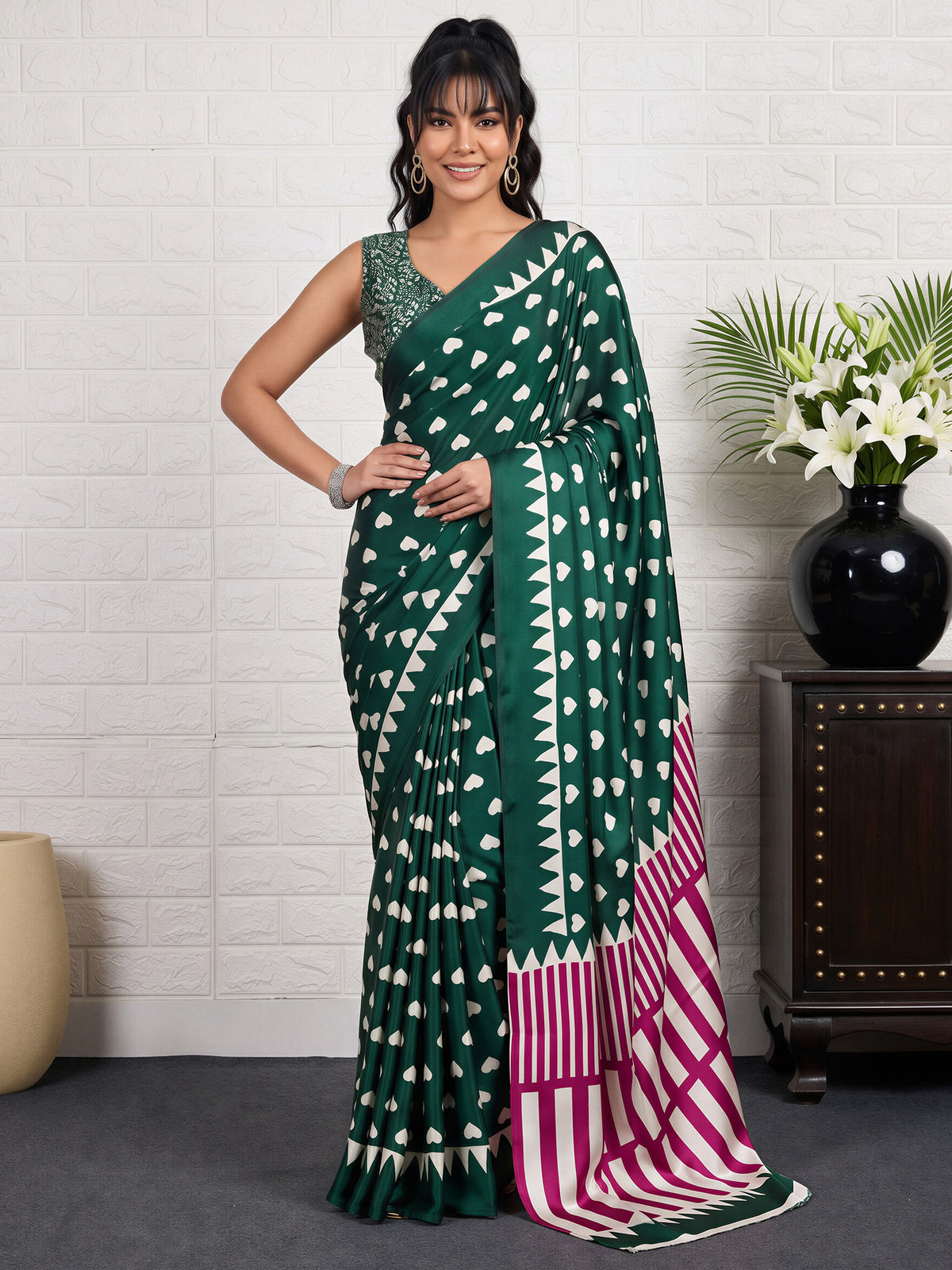 Woman wearing green satin saree with traditional indian motif work and green blouse