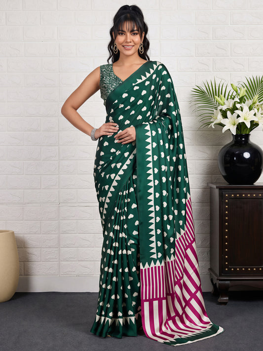 Woman wearing green satin saree with traditional indian motif work and green blouse