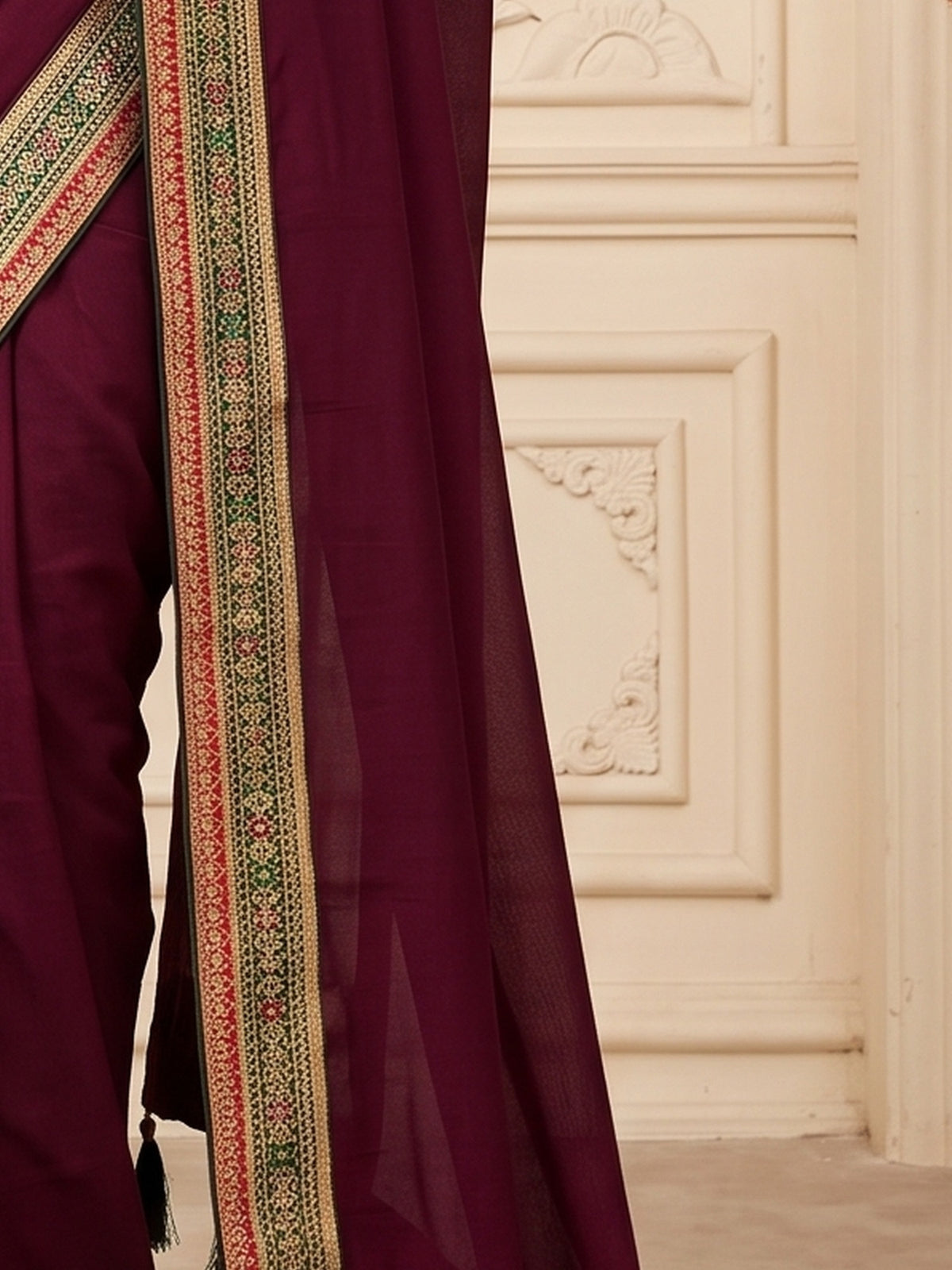 Pallu detail of wine vichitra silk saree showing clean solid-tone finish and embellished border