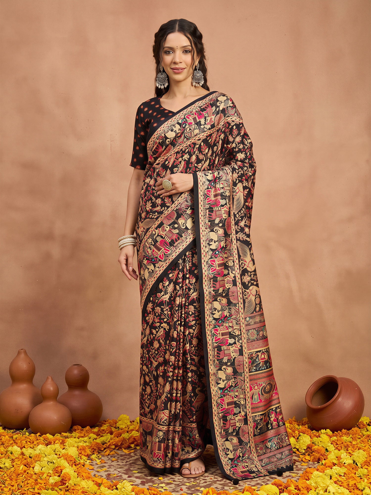 Woman wearing black silk blend saree with metallic foil print work and black blouse