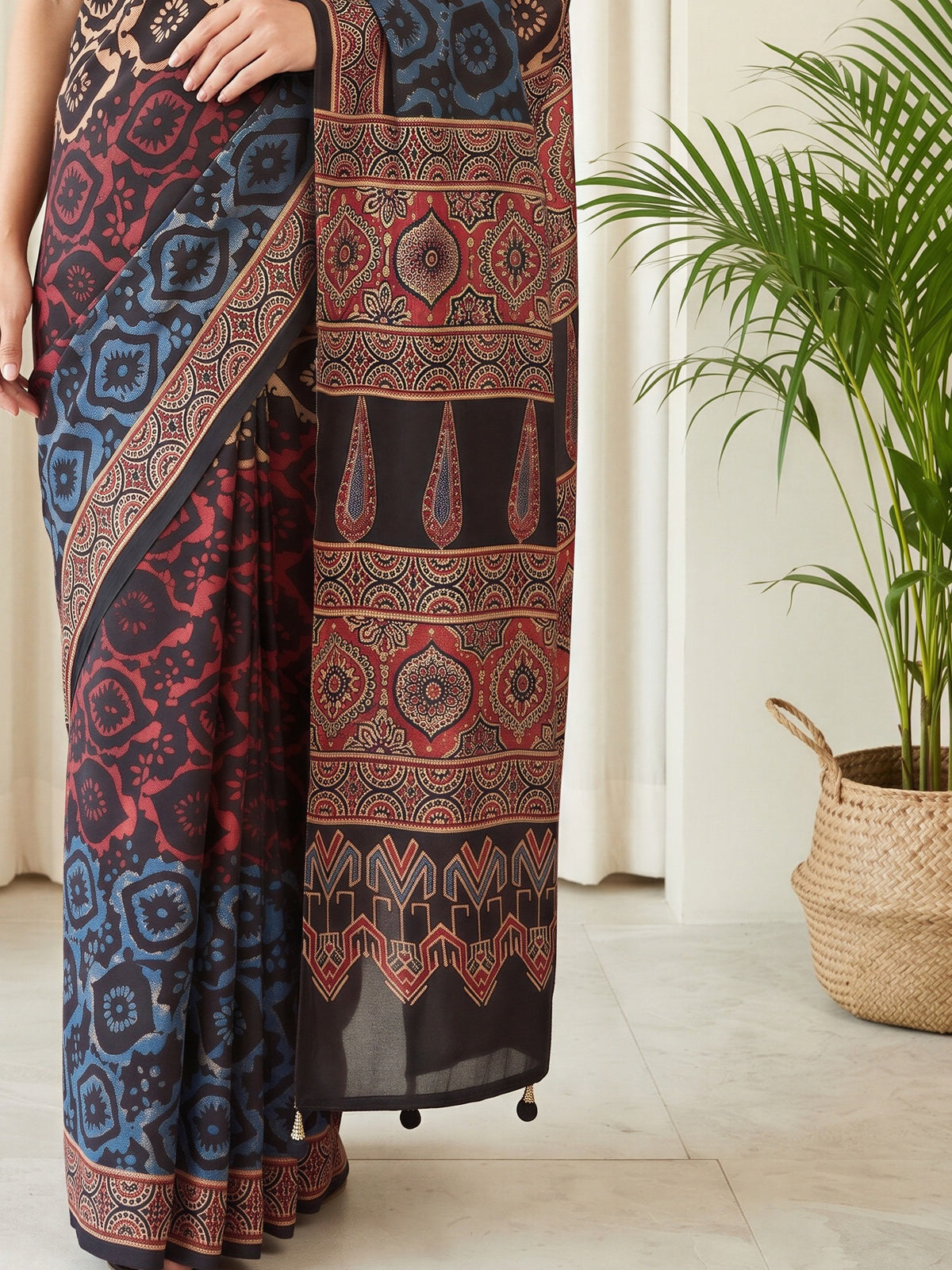 Pallu detail of beige silk blend saree showing traditional indian motif work and printed border
