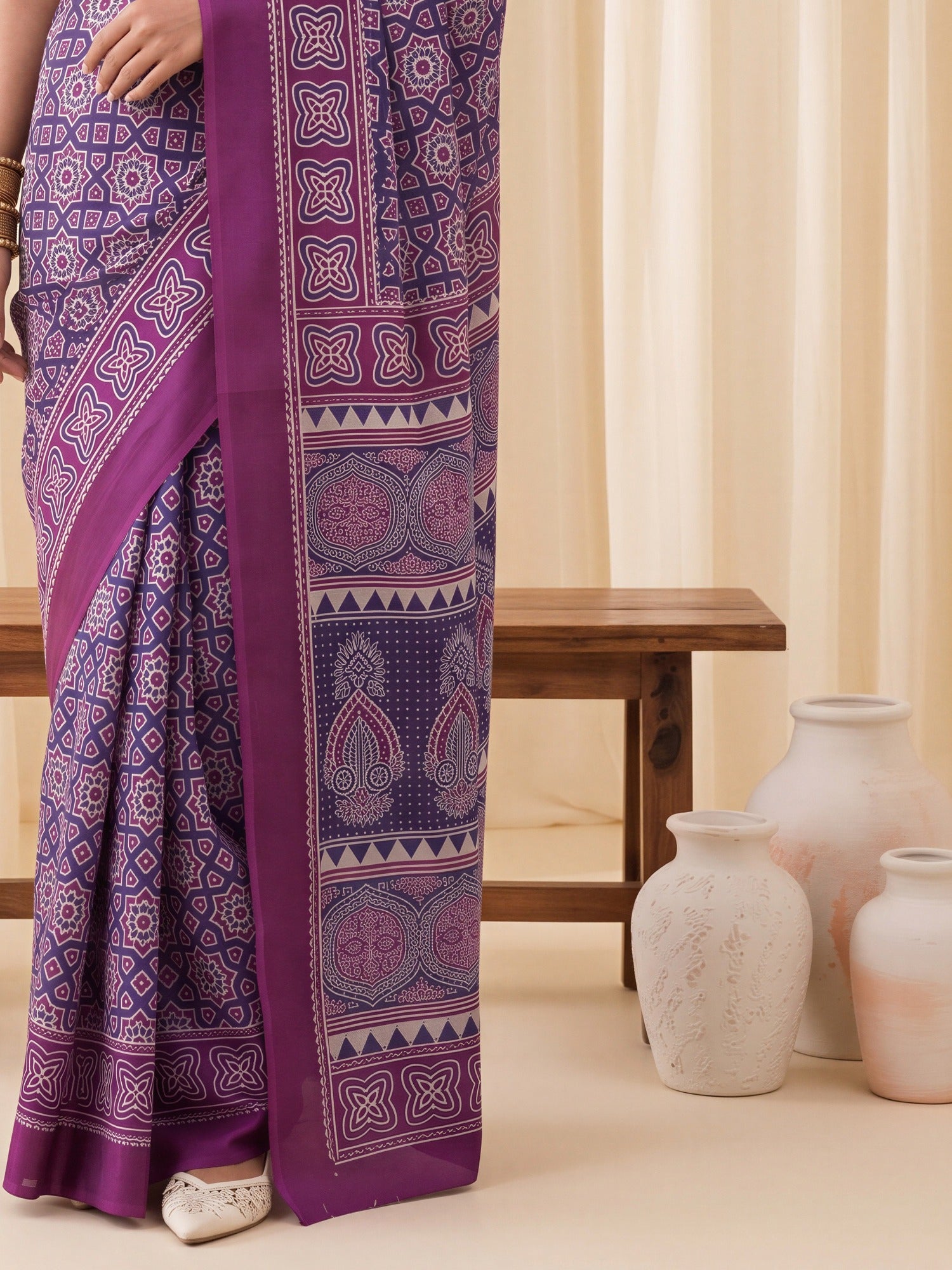 Pallu detail of purple crepe saree showing ajrak block-print motif work and printed border