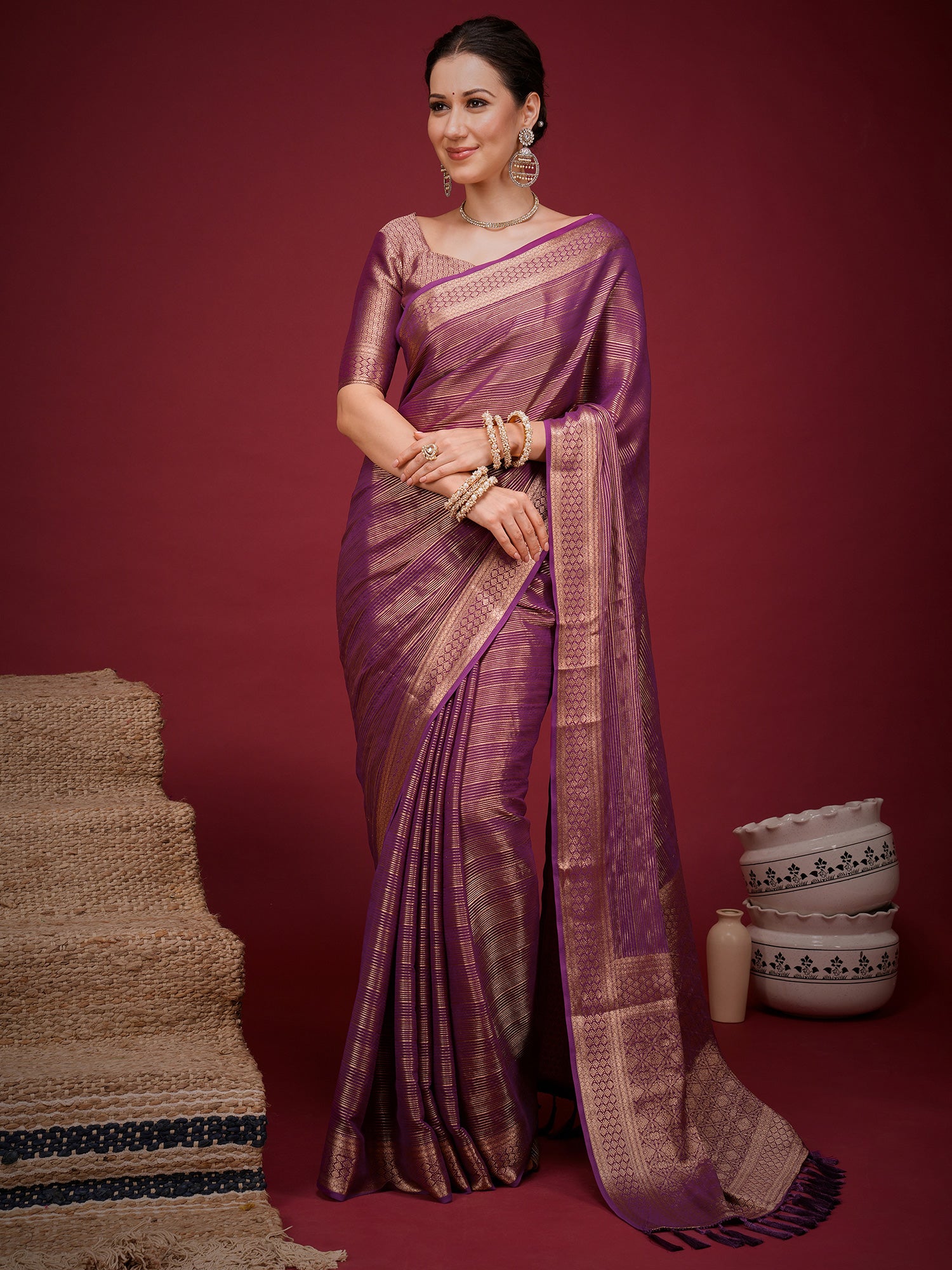 Woman wearing magenta viscose silk saree with striped pattern design and magenta blouse
