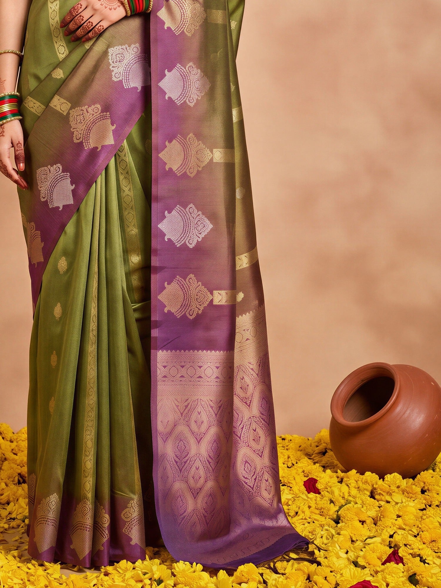 Pallu detail of green cotton blend saree showing ornamented surface design and zari border