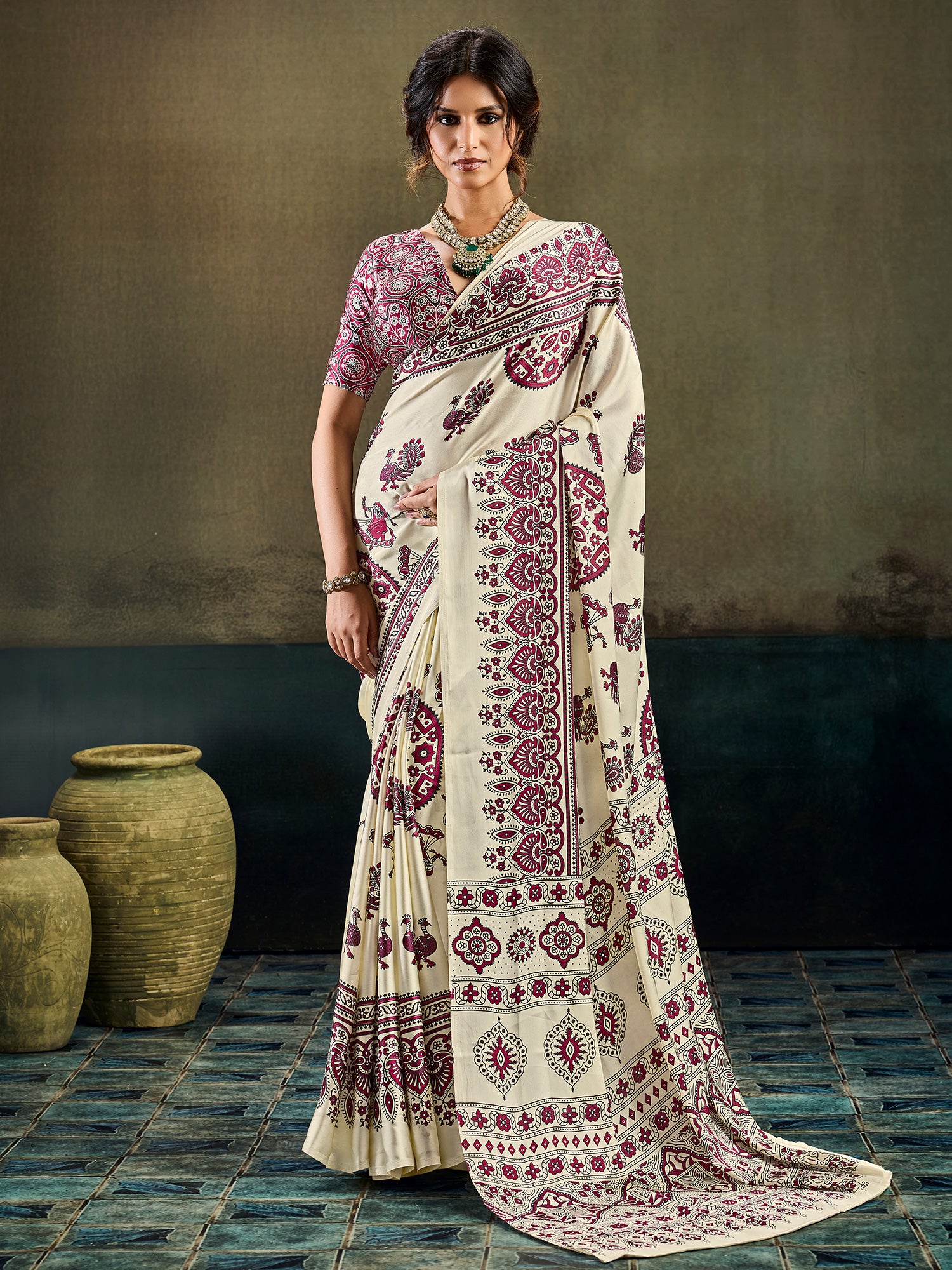 Woman wearing cream satin saree with ajrak block-print motif work and maroon blouse