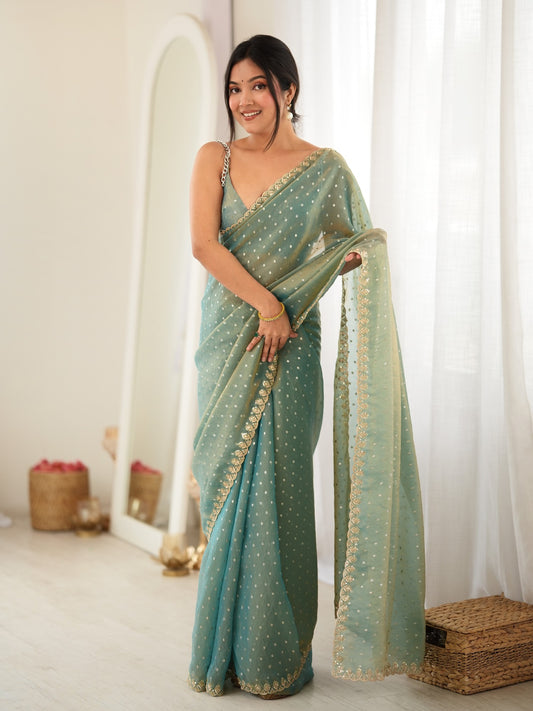 Woman wearing light blue georgette saree with zari butta (metallic motif) work and light blue blouse