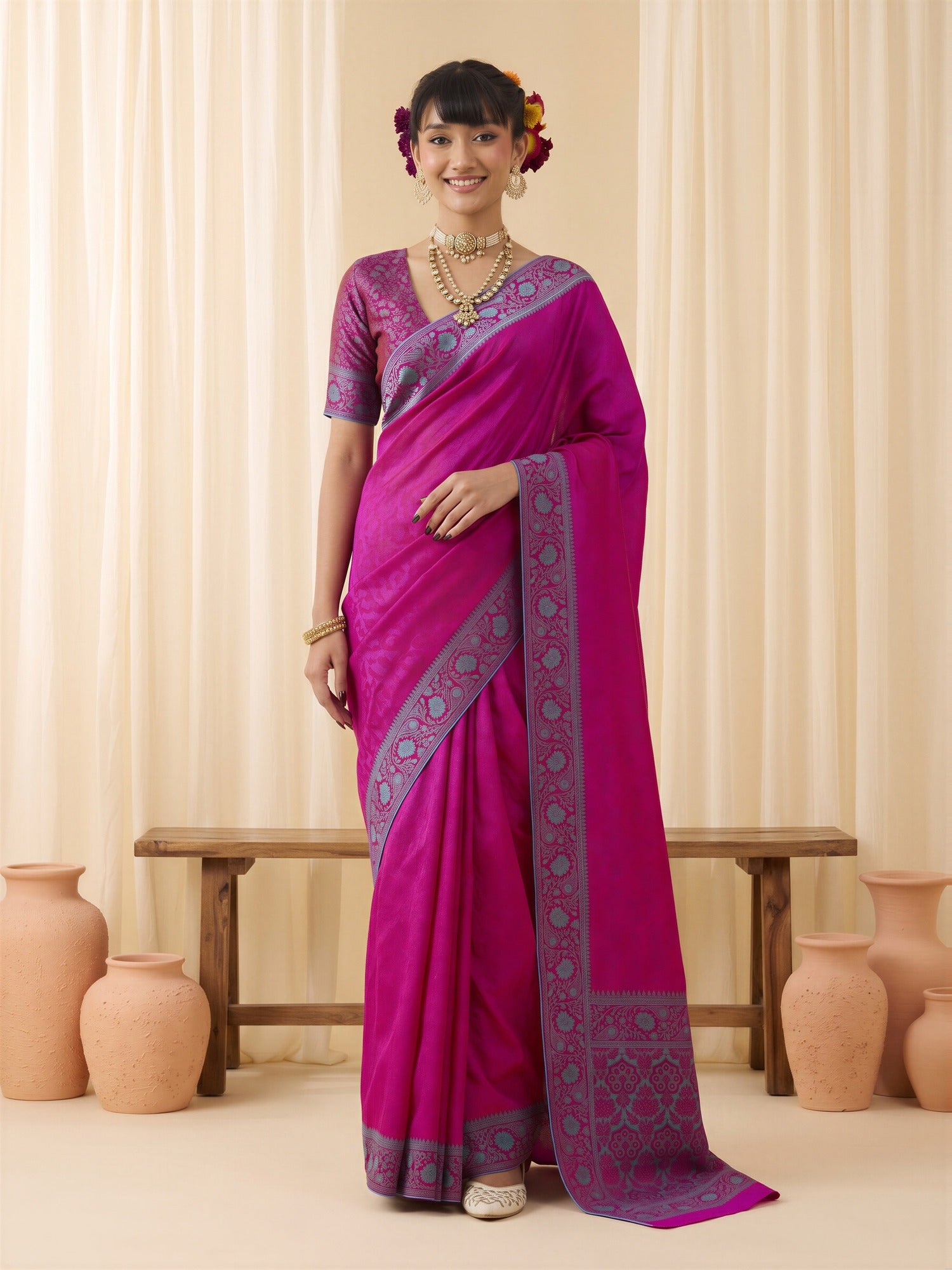 Woman wearing magenta silk blend saree with traditional indian motif work and magenta blouse