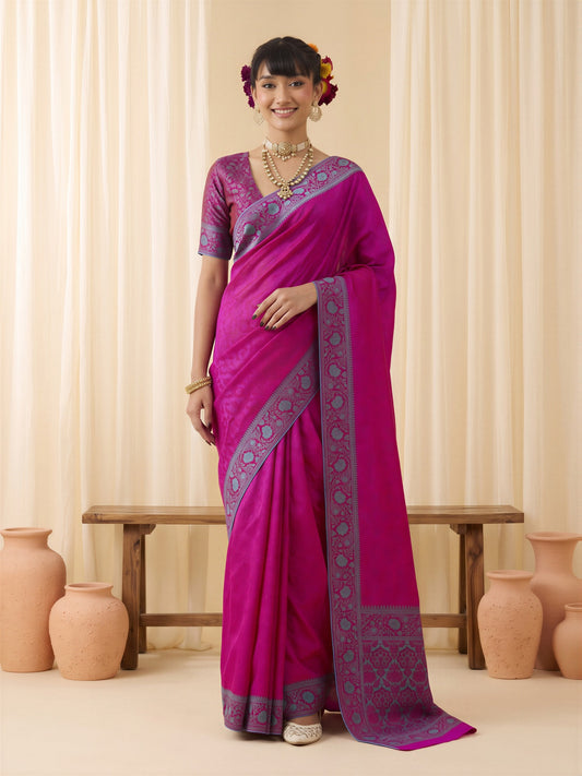 Woman wearing magenta silk blend saree with traditional indian motif work and magenta blouse