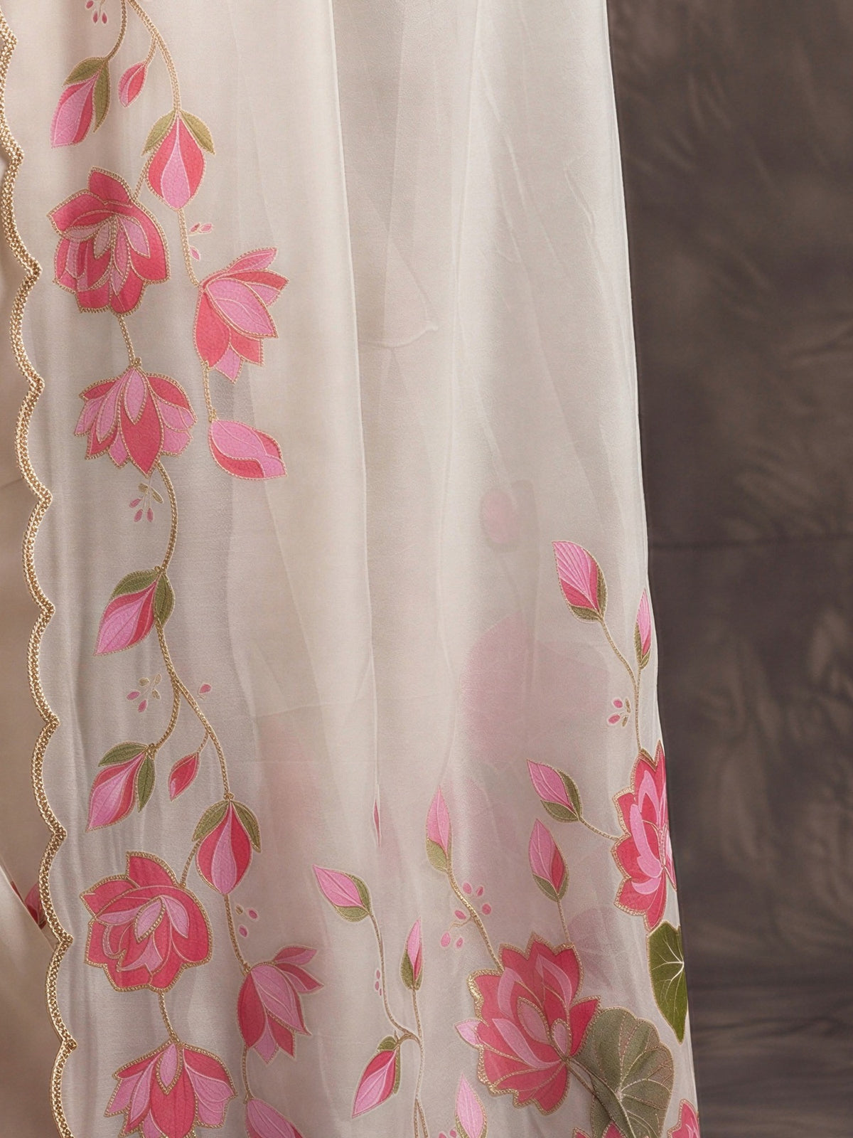 Pallu detail of off white satin saree showing all-over floral design and embellished border