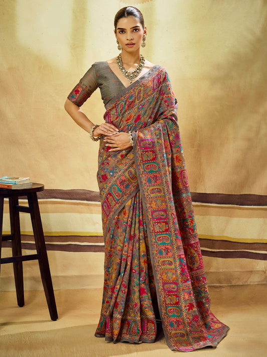 Woman wearing grey muga cotton saree with traditional indian motif work and grey blouse