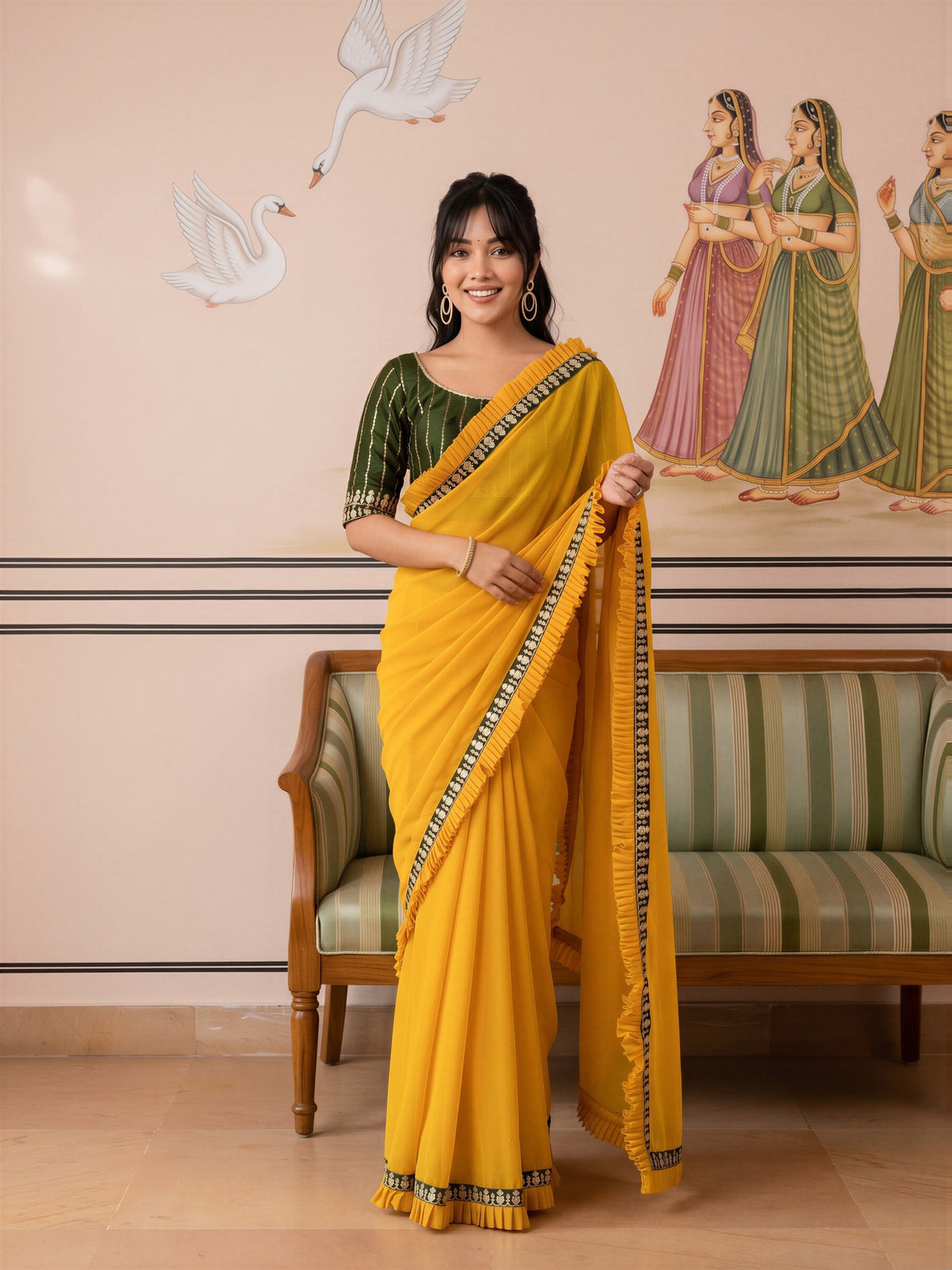 Woman wearing yellow georgette saree with ornamented surface design and green blouse