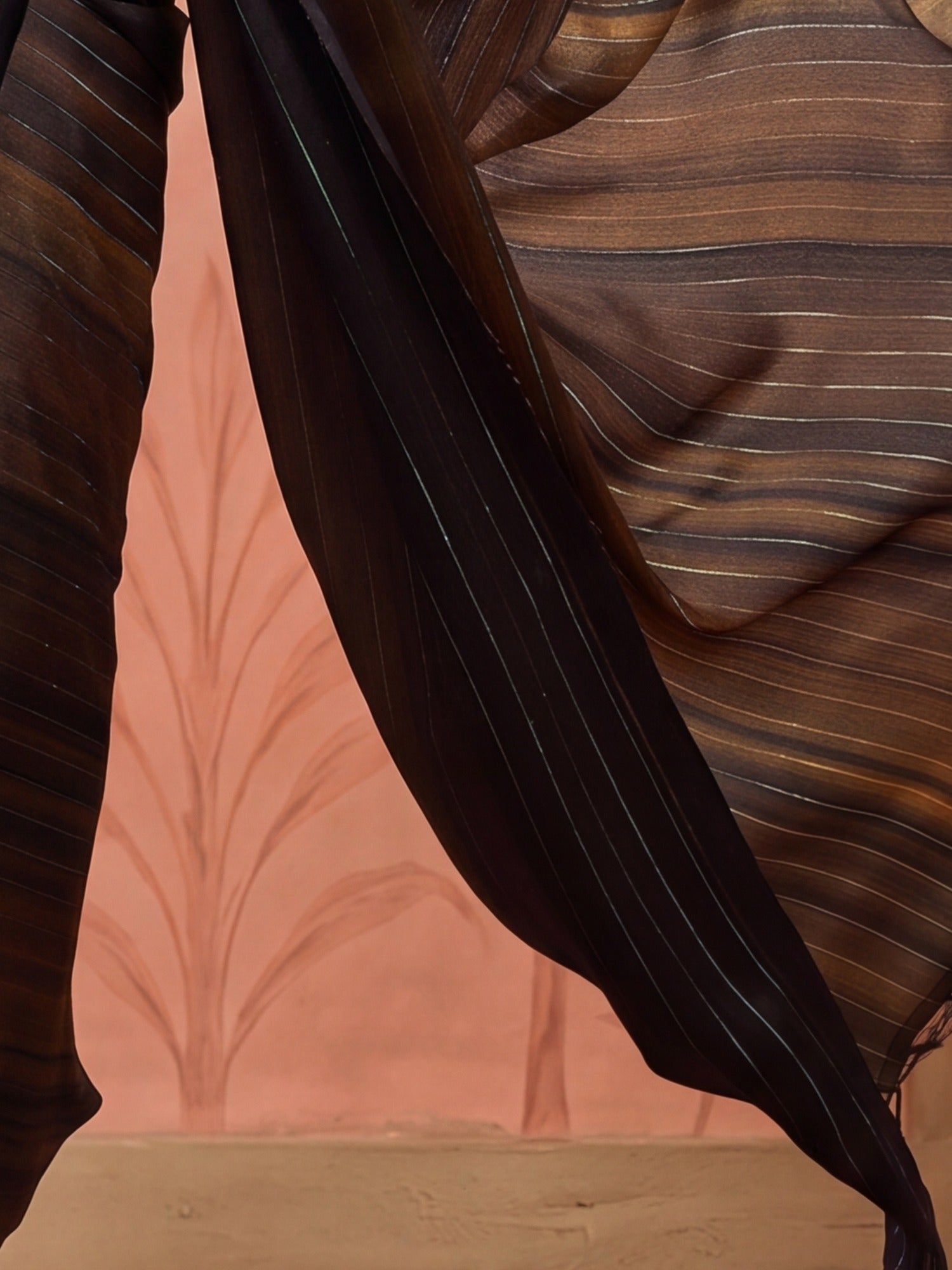 Pallu detail of black poly georgette saree showing striped pattern design and solid border