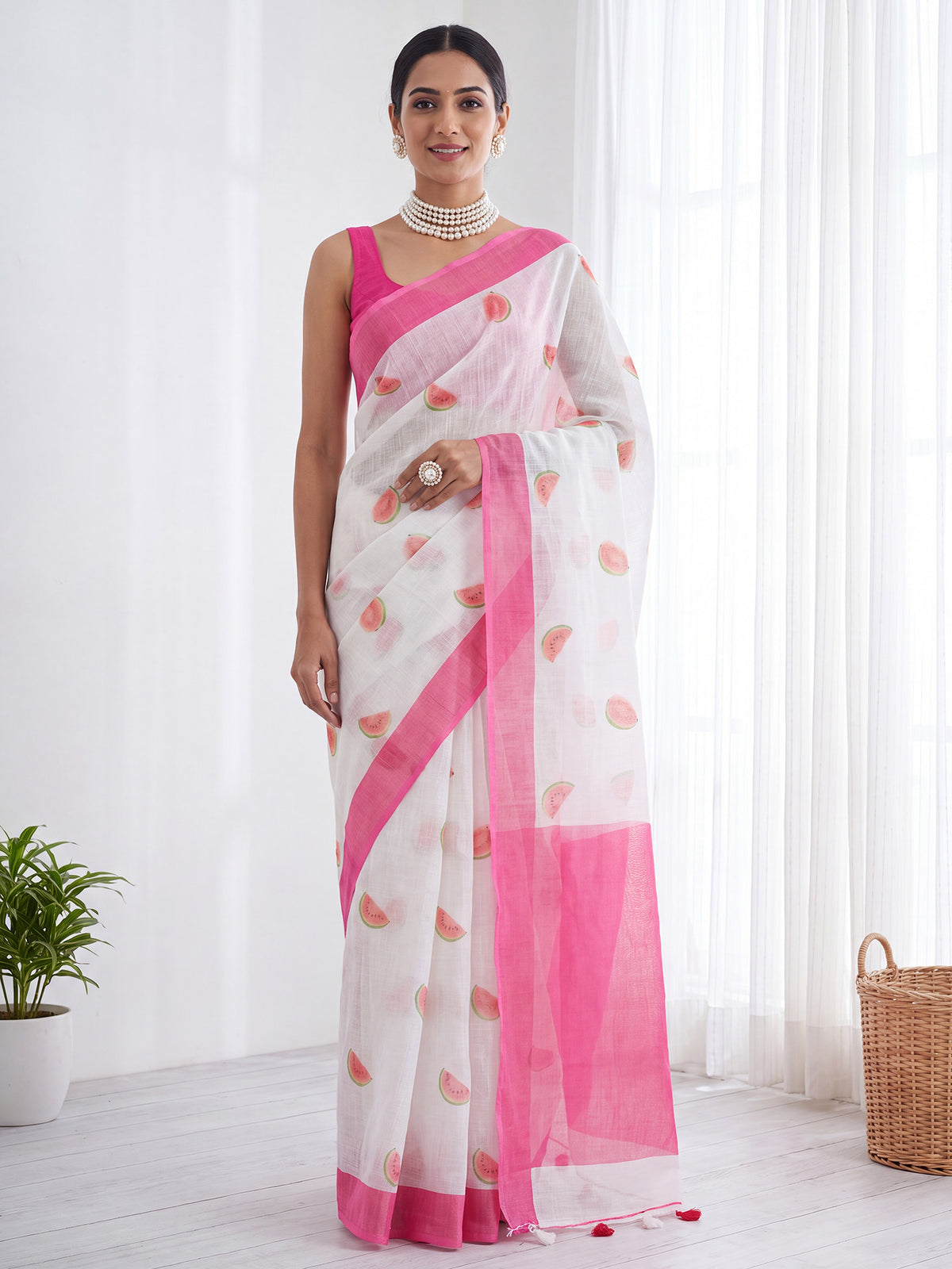 Woman wearing pink cotton linen saree with quirky design and pink blouse