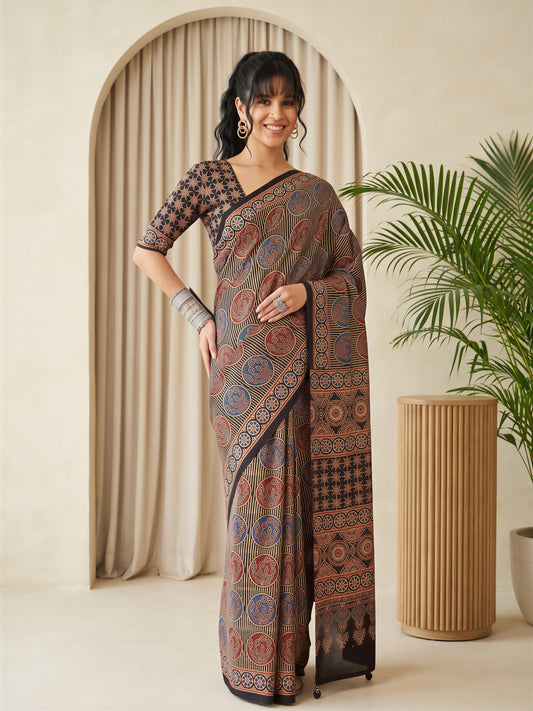 Woman wearing black silk blend saree with traditional indian motif work and black blouse