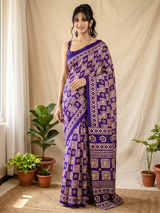 Woman wearing purple cotton blend saree with batik wax-resist design and purple blouse