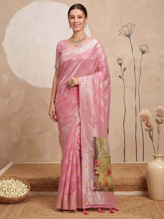 Woman wearing pink organza saree with traditional indian motif work and pink blouse