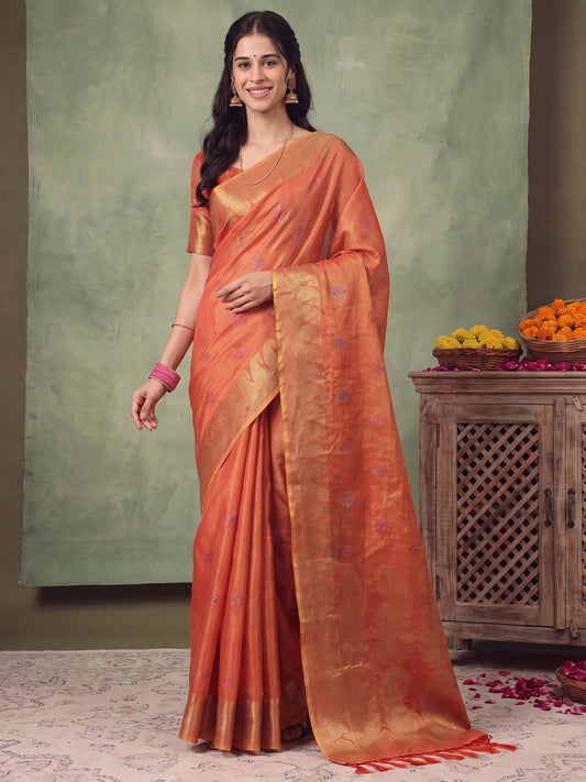 Woman wearing rust linen saree with traditional indian motif work and rust blouse