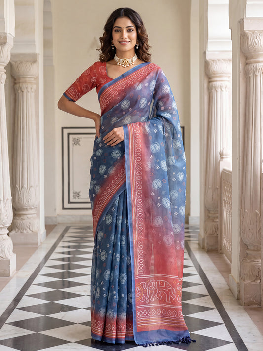 Woman wearing teal blue cotton silk saree with shibori resist-dye pattern and peach blouse