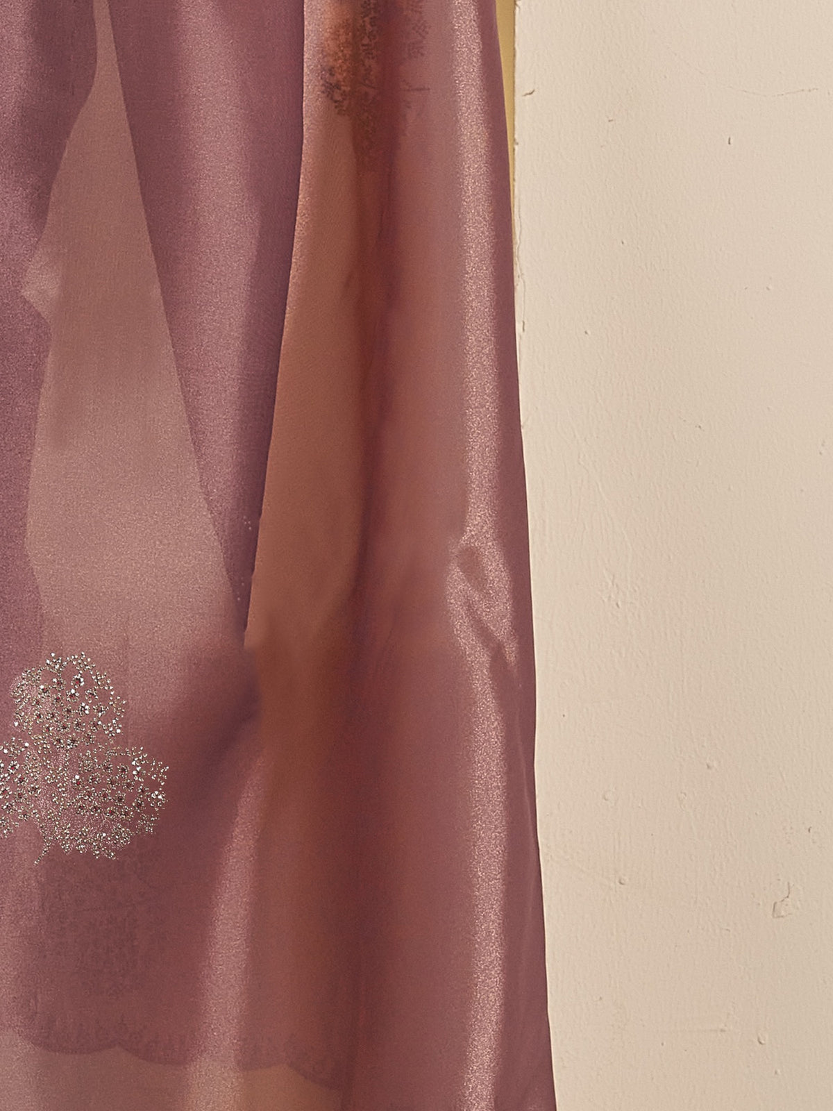Pallu detail of mauve organza saree showing ornamented surface design and scallop border