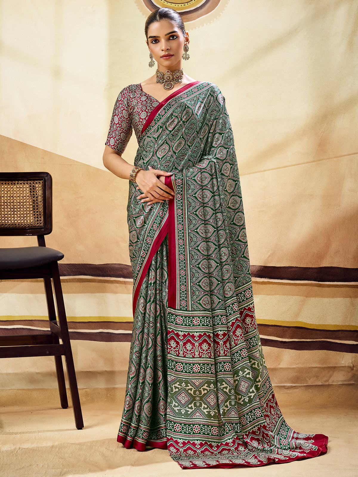 Woman wearing green satin saree with ajrak block-print motif work and maroon blouse