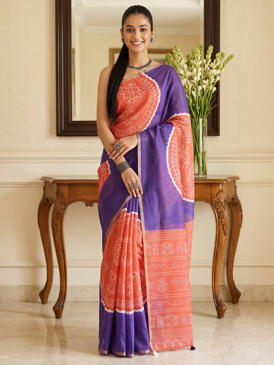 Woman wearing purple cotton blend saree with bandhani tie-dye dot work and coral blouse