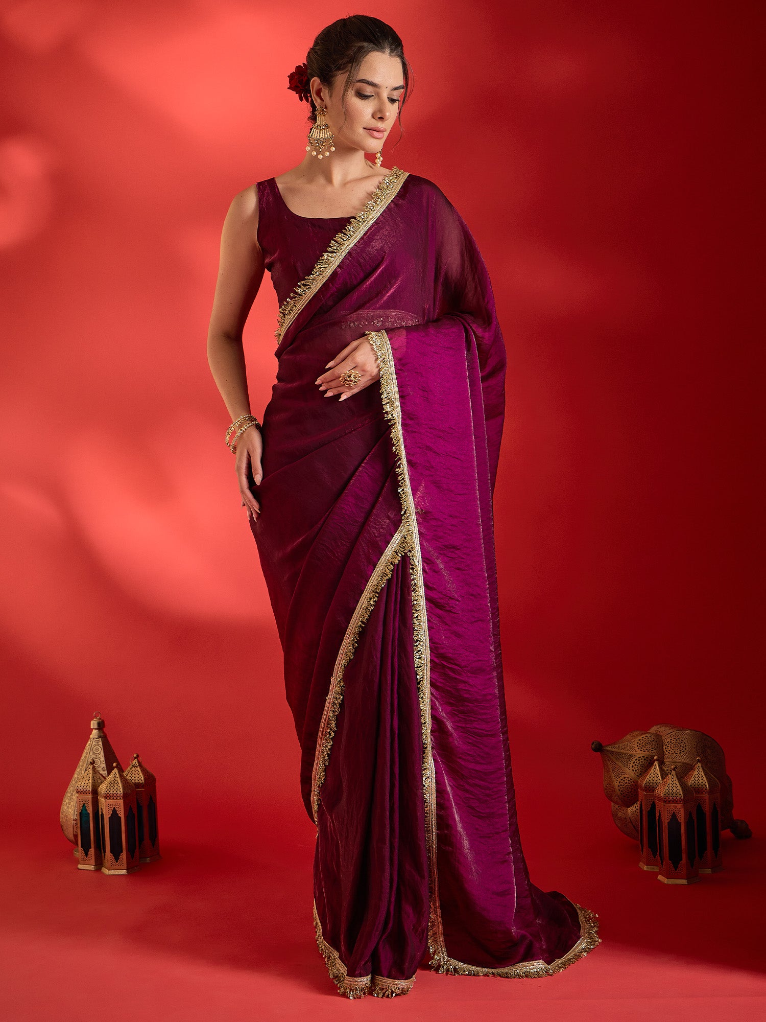 Woman wearing wine satin saree with clean solid-tone finish and wine blouse