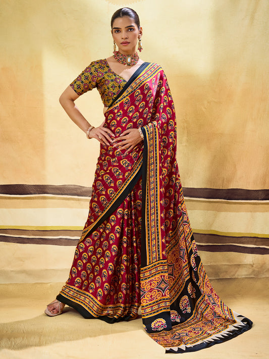 Woman wearing maroon satin saree with ajrak block-print motif work and mustard blouse