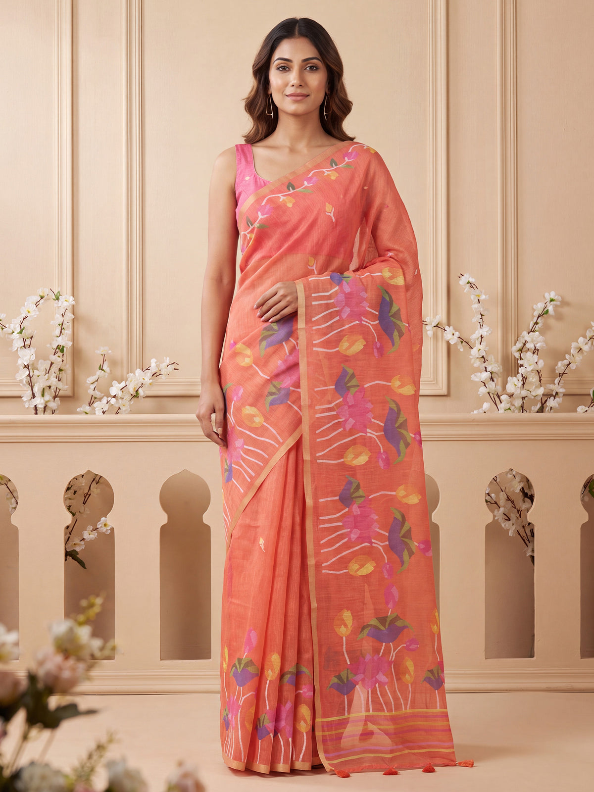 Woman wearing rust cotton linen saree with botanical floral and leaf design and pink blouse