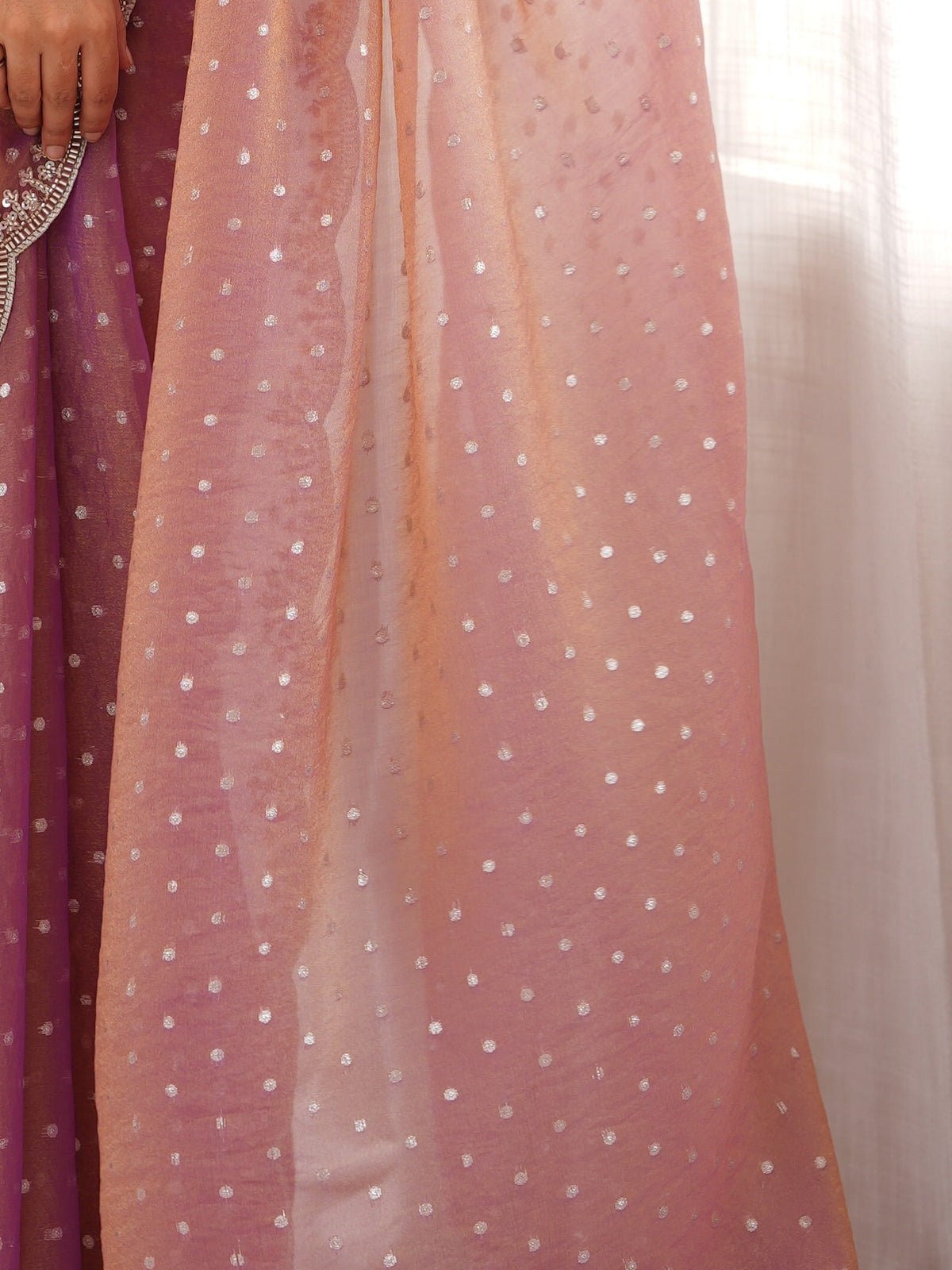 Pallu detail of mauve silk blend saree showing ornamented surface design and scallop border