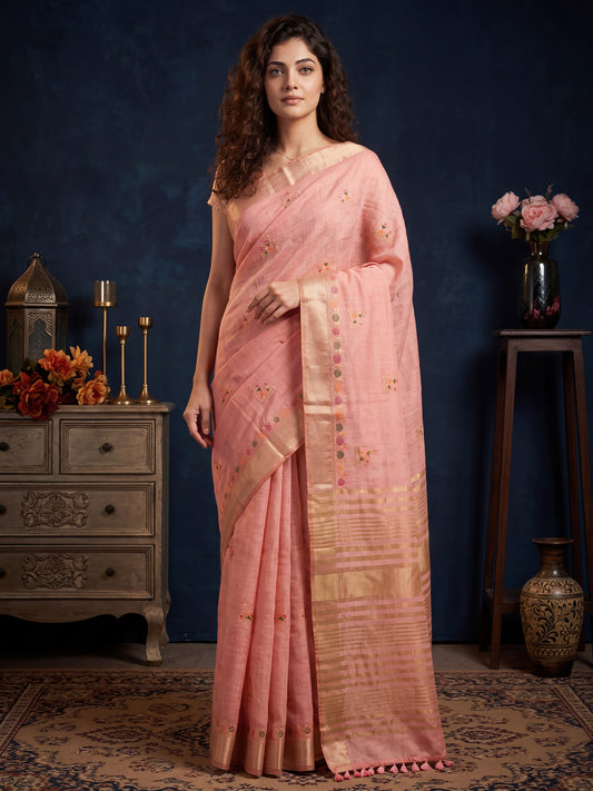 Woman wearing pink cotton linen saree with embroidered motif work and pink blouse