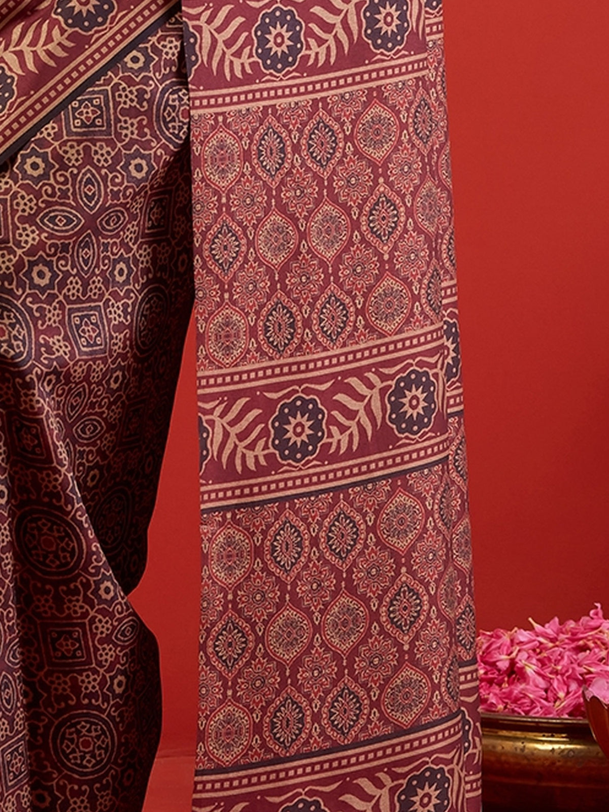 Pallu detail of maroon silk blend saree showing ajrak block-print motif work and printed border
