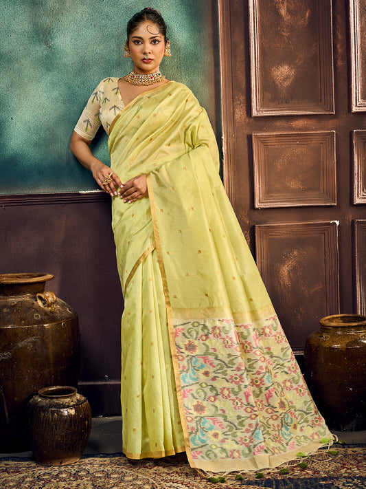Woman wearing light green cotton silk saree with zari butta (metallic motif) work and light green blouse