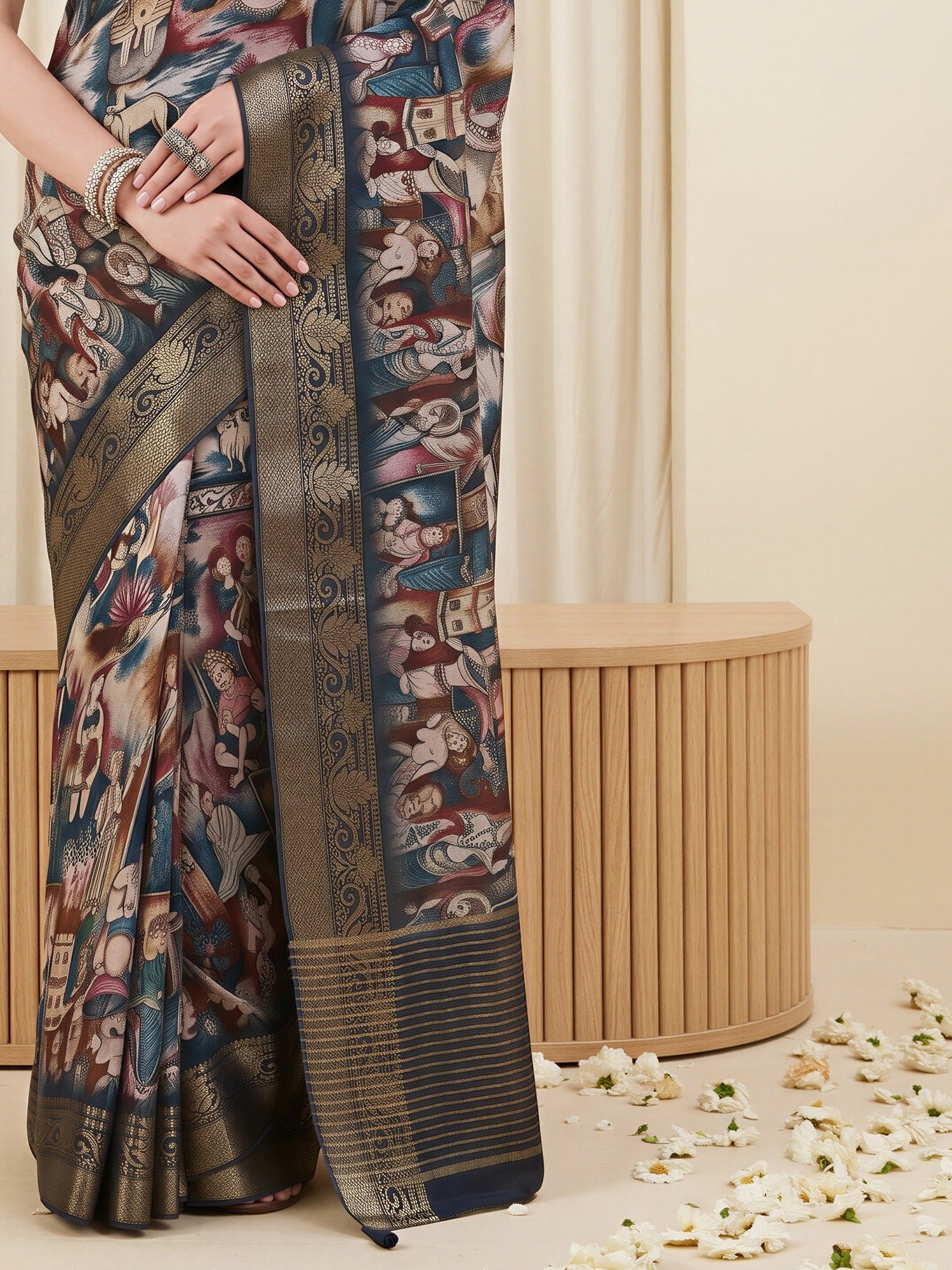 Pallu detail of navy blue viscose silk saree showing kalamkari narrative motif work and woven design border