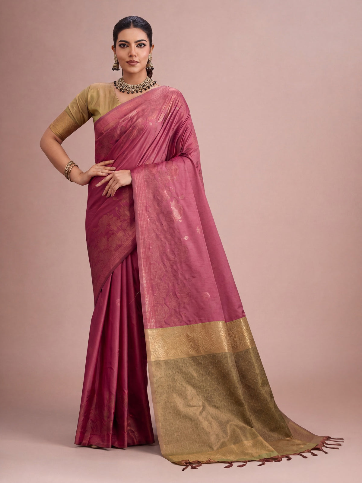 Woman wearing mauve tussar silk saree with traditional indian motif work and light green blouse