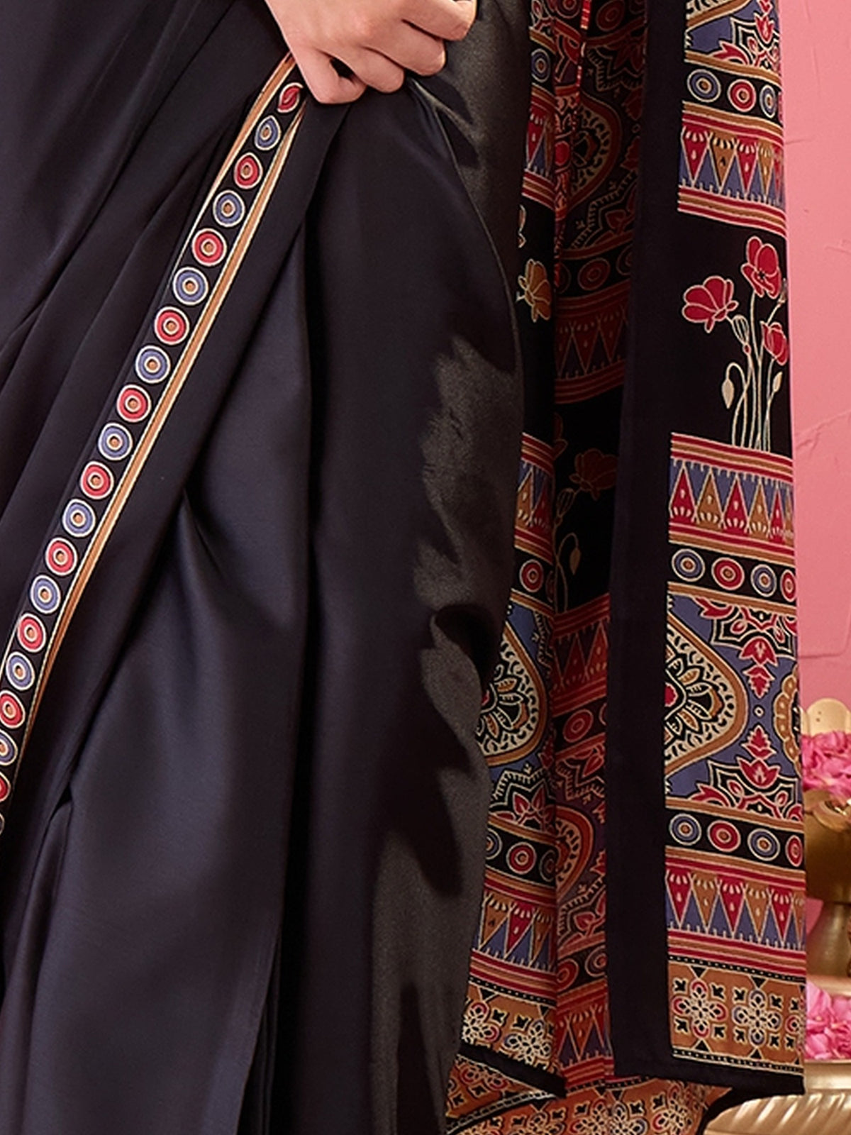 Pallu detail of black satin saree showing ajrak block-print motif work and printed border