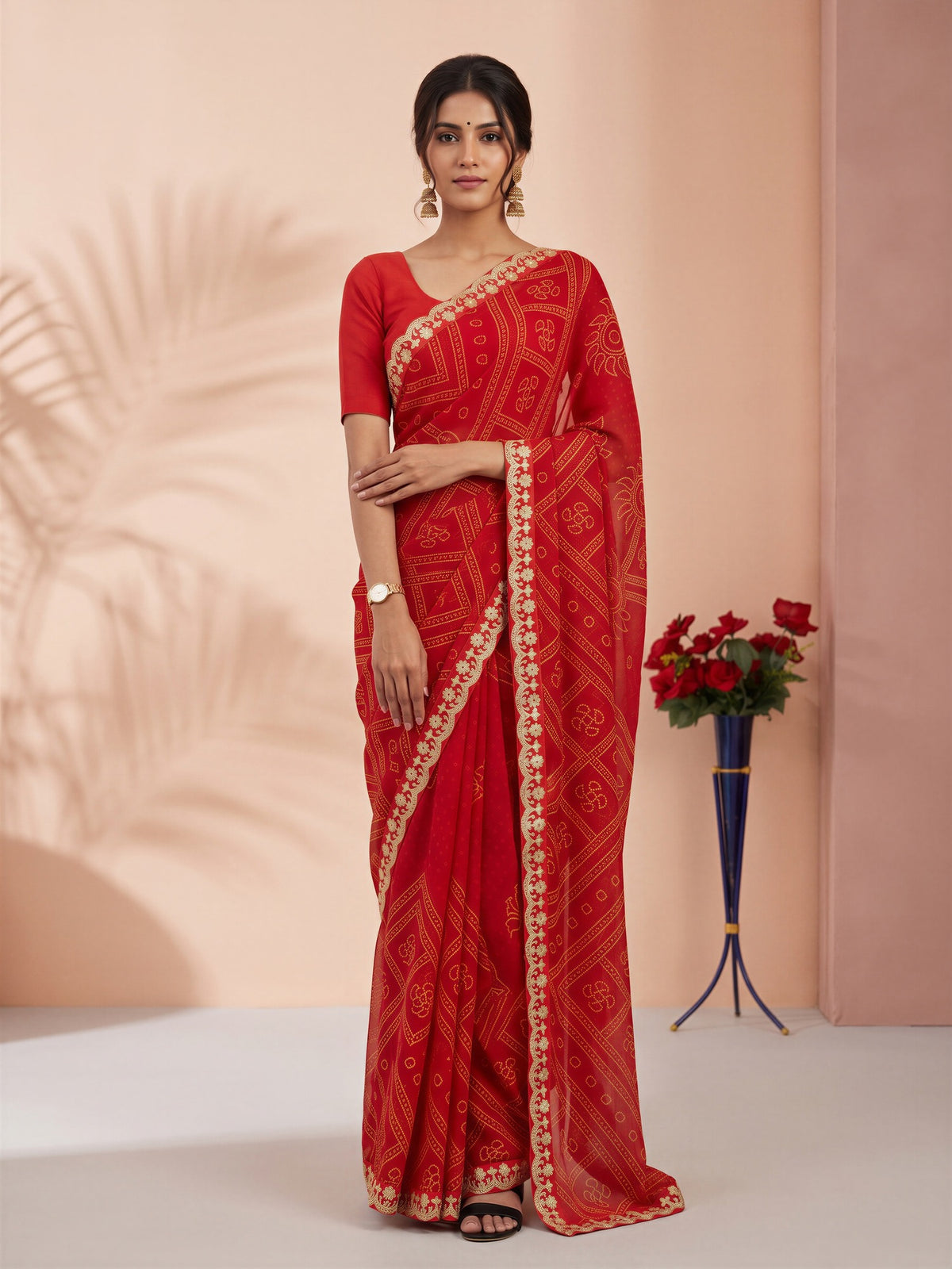 Woman wearing orange georgette saree with bandhani tie-dye dot work and orange blouse