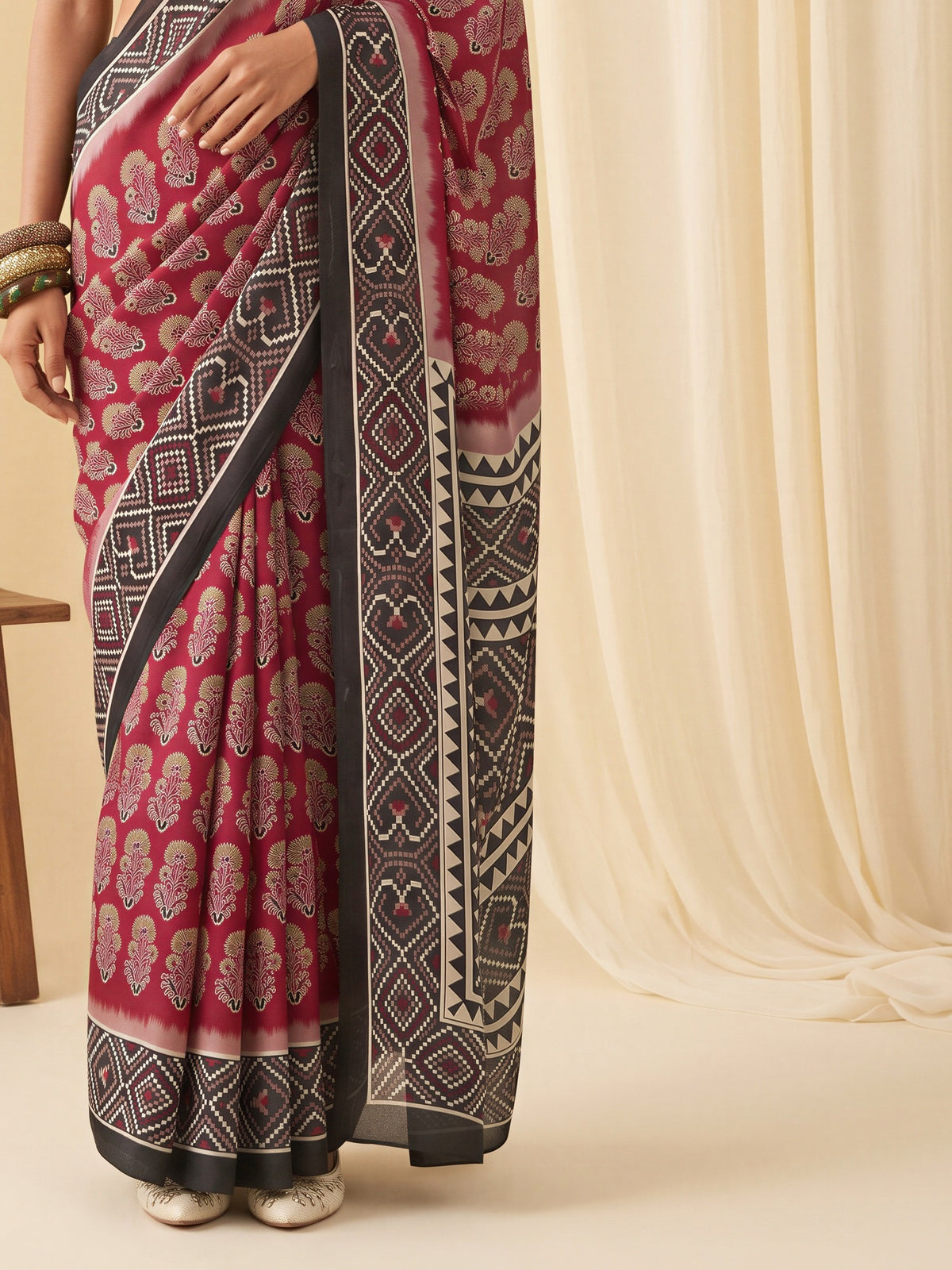 Pallu detail of maroon satin saree showing bagh block-print motif work and printed border