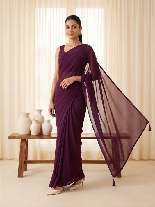 Woman wearing wine georgette saree with clean solid-tone finish and wine blouse