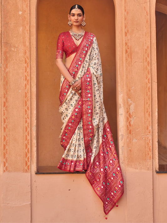 Woman wearing cream silk blend saree with ikat resist-dyed pattern and red blouse