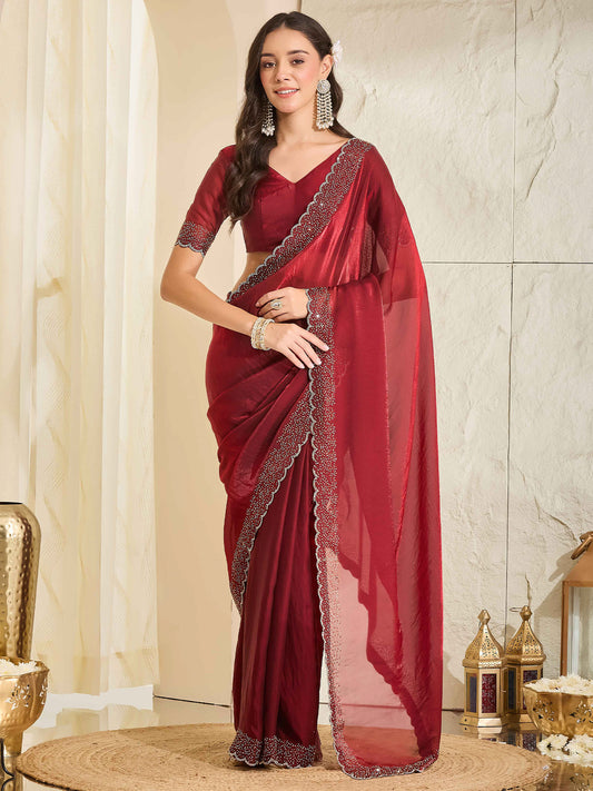 Woman wearing maroon satin saree with clean solid-tone finish and maroon blouse