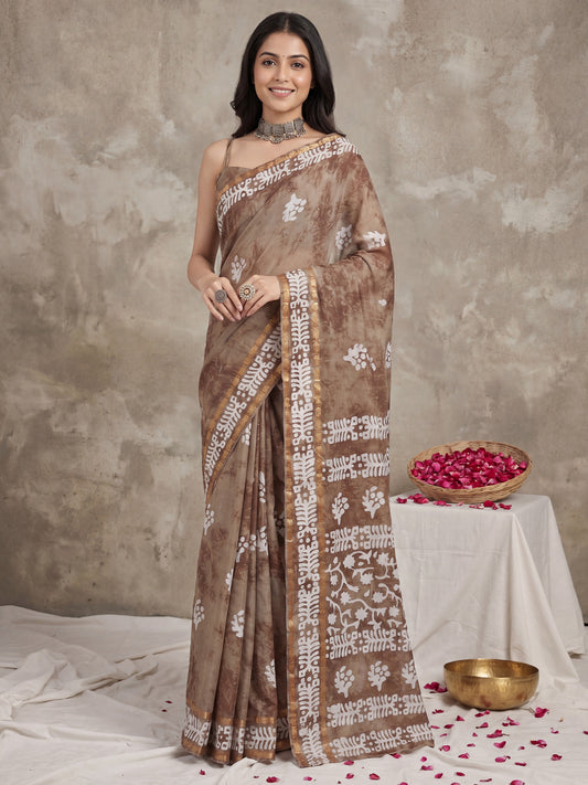 Woman wearing camel brown cotton saree with shibori resist-dye pattern and camel brown blouse