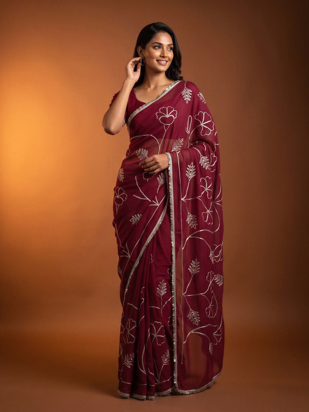Woman wearing pink georgette saree with embroidered motif work and pink blouse